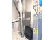 Utility room with water heater, furnace, and water softener with hexagon-tile flooring at 1056 Bent Branch Ln, Greenwood, IN 46143