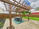 Backyard area featuring dining area with pergola and grass lawn at 1117 Oregon Way, Anderson, IN 46012