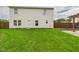Large green backyard with pergola dining area and vinyl sided home exterior at 1117 Oregon Way, Anderson, IN 46012