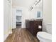 Well lit bathroom featuring wood look floors and a vanity with plenty of storage at 1117 Oregon Way, Anderson, IN 46012