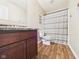 Bright bathroom featuring updated vanity with countertop and shower with curtain at 1117 Oregon Way, Anderson, IN 46012