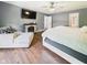 The main bedroom featuring hardwood floors, a stone fireplace, a television and access to the main bathroom at 1117 Oregon Way, Anderson, IN 46012