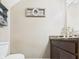 Cozy powder room featuring a granite countertop vanity and stylish wall decor at 1117 Oregon Way, Anderson, IN 46012