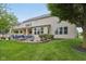Spacious backyard view features a covered patio, a fire pit, and a lush green lawn, perfect for outdoor activities at 11844 Pine Meadow Cir, Fishers, IN 46037