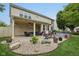 Beautiful backyard featuring a covered patio with seating, a dining area and a well-maintained lawn at 11844 Pine Meadow Cir, Fishers, IN 46037
