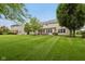 Expansive backyard featuring a covered patio, lush lawn, and mature trees, perfect for outdoor living and entertaining at 11844 Pine Meadow Cir, Fishers, IN 46037