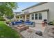 Backyard featuring a brick fire pit with outdoor seating and lush landscaping, perfect for outdoor living at 11844 Pine Meadow Cir, Fishers, IN 46037