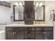 Bathroom features a dual sink vanity with dark cabinets, mosaic tile accents, and a wall-mounted television at 11844 Pine Meadow Cir, Fishers, IN 46037