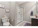 Bathroom featuring a toilet, shower with glass doors, vanity with sink and towel, and neutral-toned walls and flooring at 11844 Pine Meadow Cir, Fishers, IN 46037