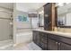 Bathroom features a dual sink vanity and a tub with mosaic tile accents and a wall-mounted television at 11844 Pine Meadow Cir, Fishers, IN 46037