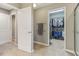 View from bathroom doorway into closet and shower, showcasing tiled floors and neutral colors at 11844 Pine Meadow Cir, Fishers, IN 46037