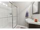 Bathroom featuring a shower with glass doors, vanity with sink and towel, and neutral-toned walls and flooring at 11844 Pine Meadow Cir, Fishers, IN 46037