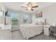 This bedroom features neutral walls, carpet floors, a ceiling fan, and windows with natural light at 11844 Pine Meadow Cir, Fishers, IN 46037