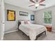 This bedroom includes wall decor, carpet floors, a ceiling fan, and a window for natural lighting at 11844 Pine Meadow Cir, Fishers, IN 46037