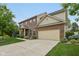 Two-story brick home featuring an attached two-car garage and manicured lawn and landscape at 11844 Pine Meadow Cir, Fishers, IN 46037
