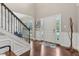 Bright foyer featuring hardwood floors, white wainscoting and trim and white front door at 11844 Pine Meadow Cir, Fishers, IN 46037