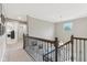 Upstairs hallway features a chandelier, decorative railing, and views overlooking the entry at 11844 Pine Meadow Cir, Fishers, IN 46037