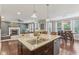 Open concept kitchen island featuring granite counters, stainless steel appliances, and views into living area at 11844 Pine Meadow Cir, Fishers, IN 46037