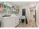 A view of the laundry room featuring shelving, a washer and dryer, and a chalkboard at 11844 Pine Meadow Cir, Fishers, IN 46037