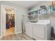 A view of the laundry room with shelving, a washer and dryer, and closet access at 11844 Pine Meadow Cir, Fishers, IN 46037