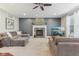 Comfortable living room featuring fireplace, plush seating, and a ceiling fan at 11844 Pine Meadow Cir, Fishers, IN 46037