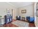 Sitting room featuring hardwood floors, gray walls, two blue accent chairs and console table at 11844 Pine Meadow Cir, Fishers, IN 46037