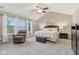 Bright main bedroom featuring a vaulted ceiling, a sitting area by the window, and soft neutral carpet at 11844 Pine Meadow Cir, Fishers, IN 46037
