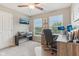 This office area has a TV, natural lighting, carpet floors, and multiple desk areas at 11844 Pine Meadow Cir, Fishers, IN 46037