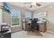 This office area has a TV, natural lighting, carpet floors, and a wooden desk area at 11844 Pine Meadow Cir, Fishers, IN 46037