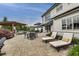 This large patio features lounge chairs, dining table and a grill for outdoor entertaining at 12437 Meeting House Rd, Carmel, IN 46032