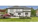 Beautiful backyard with brick home exterior, well manicured lawn, and an outdoor seating area at 12437 Meeting House Rd, Carmel, IN 46032