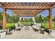 Backyard patio features a cozy seating area under a pergola and lush landscaping at 12437 Meeting House Rd, Carmel, IN 46032