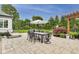 Gorgeous backyard features a patio with a dining area, chaise lounge and play set at 12437 Meeting House Rd, Carmel, IN 46032