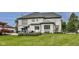 Beautiful backyard features a brick home exterior, well manicured lawn, and an outdoor seating area at 12437 Meeting House Rd, Carmel, IN 46032
