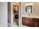 Bathroom featuring single vanity, large round mirror, and walk in closet at 12437 Meeting House Rd, Carmel, IN 46032