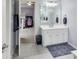 Bathroom with double towel racks, a mirror and vanity, and a door leading to the bedroom at 12437 Meeting House Rd, Carmel, IN 46032