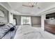 Bright bedroom featuring tray ceilings, neutral decor, and large windows allowing ample natural light at 12437 Meeting House Rd, Carmel, IN 46032
