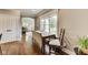 This home features a breakfast nook with wood floors, large windows, and access to the outdoors at 12437 Meeting House Rd, Carmel, IN 46032