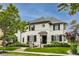 Stunning two-story home featuring a well-manicured lawn, black shutters, and beautiful landscaping at 12437 Meeting House Rd, Carmel, IN 46032