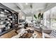Stylish home office features custom built-ins, hardwood floors, natural light, and a comfortable seating area at 12437 Meeting House Rd, Carmel, IN 46032