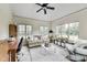 This home features a home office with vaulted ceilings, many windows, and tile flooring at 12437 Meeting House Rd, Carmel, IN 46032