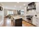 This home features a kitchen with a center island, white countertops, stainless appliances, and a custom hood at 12437 Meeting House Rd, Carmel, IN 46032