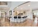 This home features a kitchen with hardwood floors, a center island, and bar stool seating at 12437 Meeting House Rd, Carmel, IN 46032