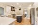 This home features a kitchen with white countertops, custom hood, and stainless steel appliances at 12437 Meeting House Rd, Carmel, IN 46032