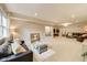 Open living room with large windows, comfortable seating, and a stylish accent shelf at 12437 Meeting House Rd, Carmel, IN 46032