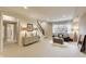 Bright living room featuring a cabinet, stairs, and comfortable seating area near a window at 12437 Meeting House Rd, Carmel, IN 46032