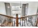 View from the second story overlooking the spacious living room with fireplace and large windows at 12437 Meeting House Rd, Carmel, IN 46032
