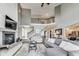 Open living area boasts high ceilings, a modern fireplace, and seamless transition to the staircase and other spaces at 12437 Meeting House Rd, Carmel, IN 46032
