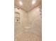 Up close view of the tiled shower featuring built-in shelves and mosaic tile accents at 12437 Meeting House Rd, Carmel, IN 46032
