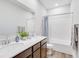 Bright bathroom featuring a double sink vanity, modern fixtures, and a shower-tub combo at 13406 Vickery Ridge Dr, Fishers, IN 46037
